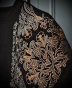 Close-up of a black Sweatshirt with intricate gold floral embroidery by vivant wear